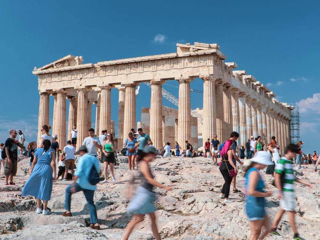 Tourists have a guided tour of the Parthenon in Athens
